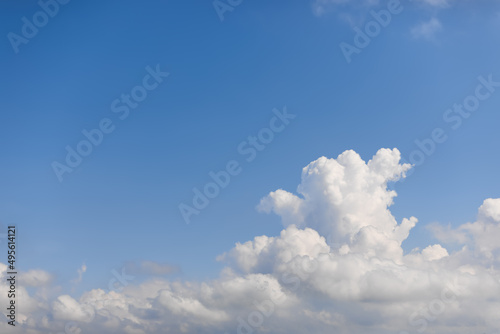 Morning subtle blue sky background with a huge shapeless cumulus cloud