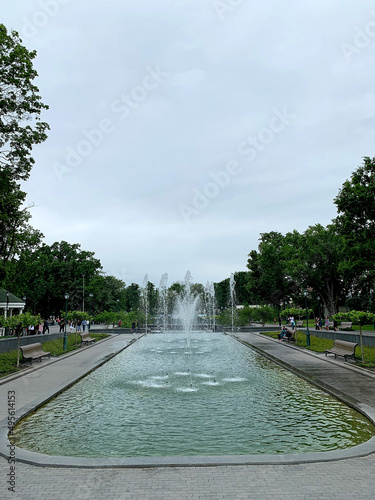 Fountain in the pond among the Shevchenko City Garden in Kharkiv, Ukraine in summer cloudy day, Soft focus