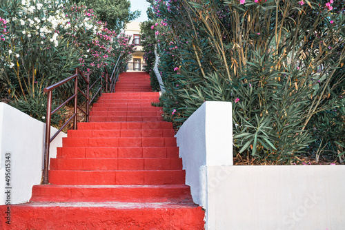 Red staircase uphill with stone steps. Career growth concept.