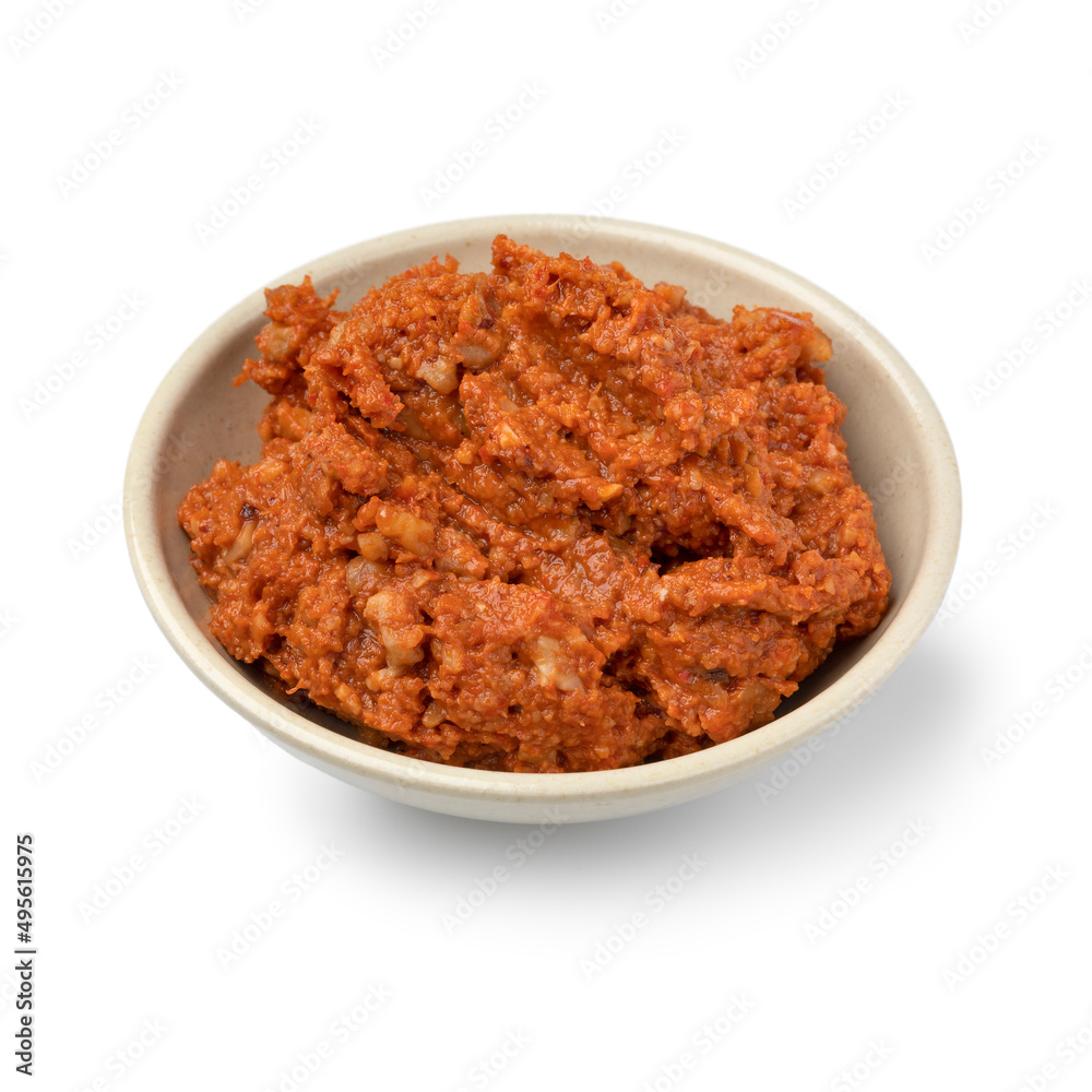 Bowl with fresh made muhammara close up isolated on white background Bowl with fresh made muhammara close up isolated on white background