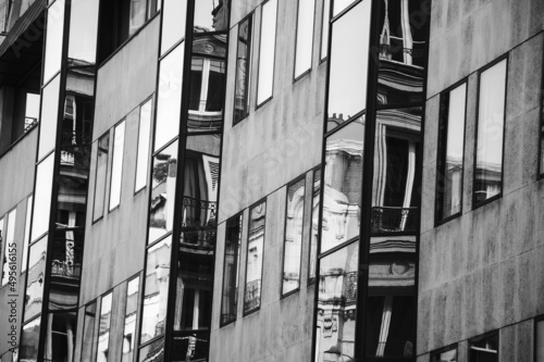 Parisian classical building reflected in modern one. Urban contrasts. Black white historic photo. photo