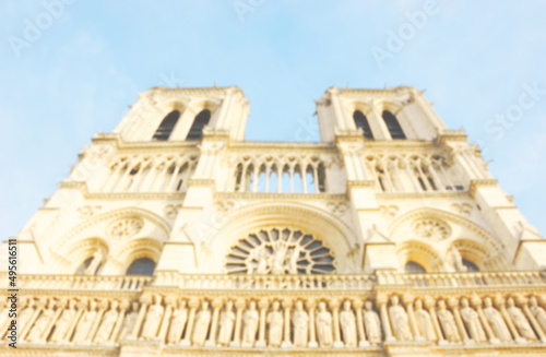 Blurry photo of Notre Dame Cathedral in Paris, France. Bright Easter holiday mood religious background.