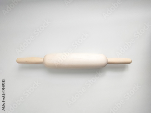 Rolling pin from natural wood on white background. Kitchen utensil. 