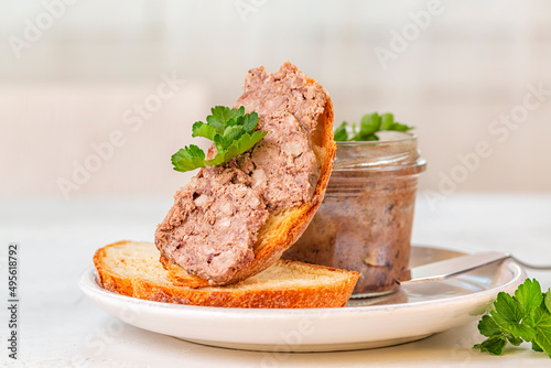 Billede på lærred Duck Terrine  on a bread slice. Pâté with Armagnac. White table.