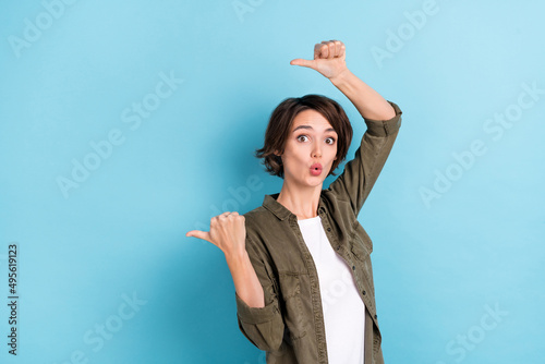 Photo of impressed young bob hairdo lady index promo wear khaki shirt isolated on blue color background