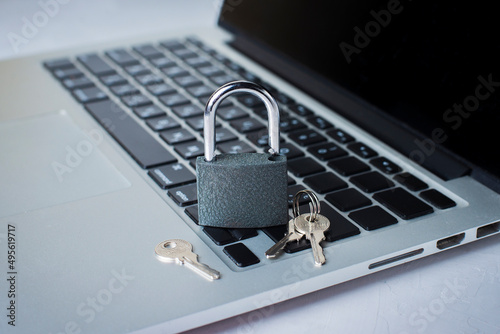Concept of internet data protection. Security system. Using laptop safety. Development of reliable online protection system. Laptop and padlock with keys on the table. Network hacking protection.