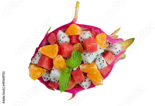 Tropical fruit salad with dragon fruit, watermelon and orange served in half a dragon fruit on white background. clipping path. © Yuphayao Pooh's