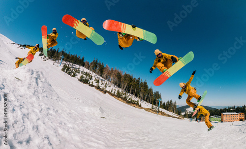 jump storyboard. a guy in an orange suit jumps with a spin on a snowboard and holds a front grab