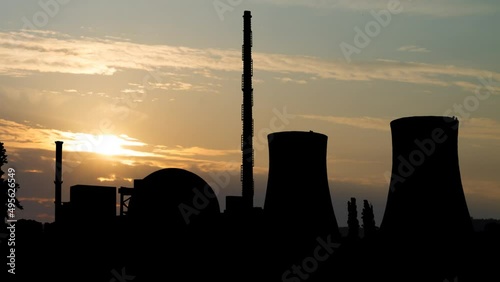 Nuclear Power Plant and Cooling Towers at Sunrise, Time Lapse with Colorful Clouds photo