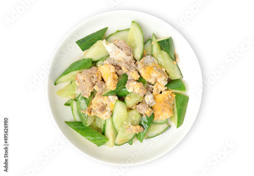 Asian stir-fried cucumber with minced pork, egg and oyster sauce in white plate on a white background. Asian food style.
