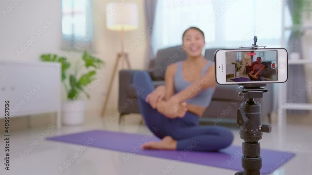 Professional yoga coach teaching online training class to students during live streaming on social media, healthcare concept Professional yoga coach teaching online training class to students during live streaming on social media, healthcare concept