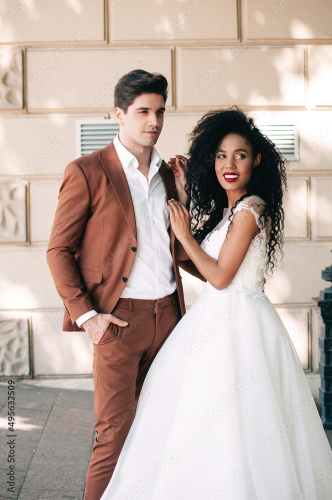 Luxurious wedding couple. Clear, even skin. Photo shoot outdoors with natural light. Portrait of a couple in love in wedding attire.