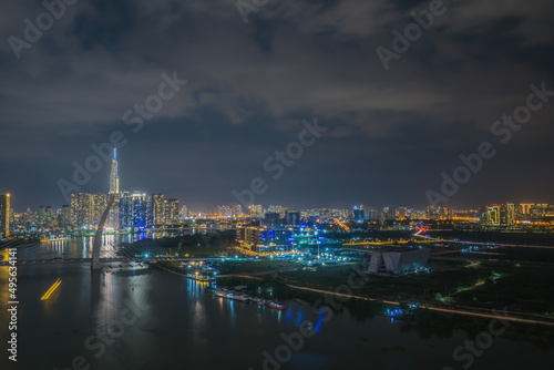 Aerial view of Bitexco Tower  buildings  roads  Thu Thiem 2 bridge and Saigon river in Ho Chi Minh city - Far away is Landmark 81 skyscrapper. This city is a popular tourist destination of Vietnam