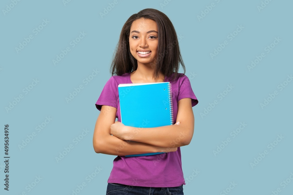 Young girl teen student in denim clothes with backpack and holds books. Education concept. Young girl teen student in denim clothes with backpack and holds books. Education concept.