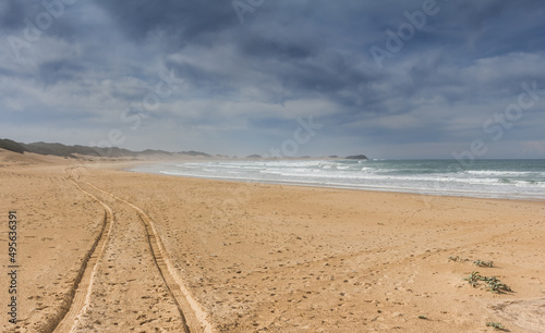 Tyre tracks on the sand of the beach - vast empty beach