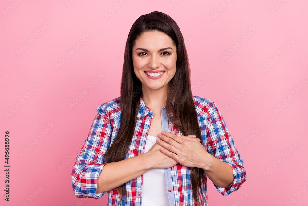 Photo of candid satisfied girl arms palms heart beaming smile look camera isolated on pink color background Photo of candid satisfied girl arms palms heart beaming smile look camera isolated on pink color background