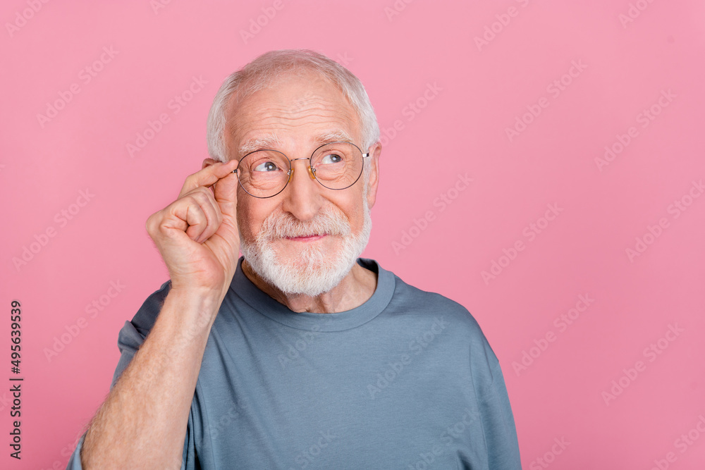 Photo of old grey hairdo man look empty space wear blue shirt isolated on pink color background