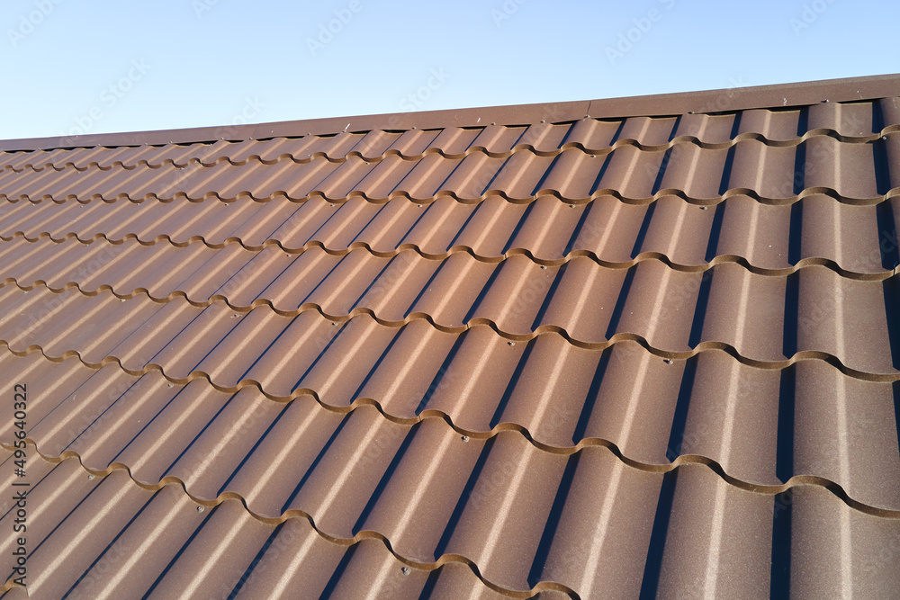 Closeup of house roof top covered with metallic shingles Closeup of house roof top covered with metallic shingles