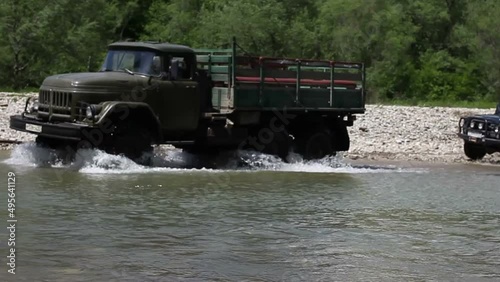 a truck travels across a mountain river