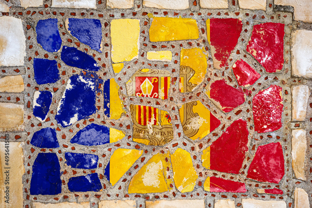 Fototapeta premium National flag of Andorra on stone wall background. Flag banner on stone texture background.