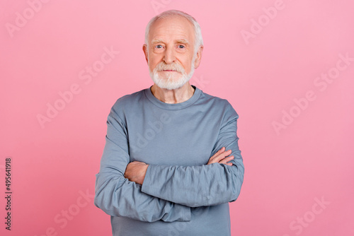 Photo of old grey hairdo man crossed arms wear blue shirt isolated on pink color background © deagreez