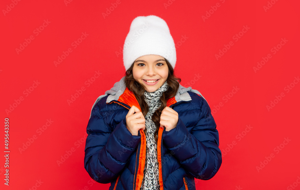 pretty teen girl on red background. portrait of child wearing warm clothes with scarf. pretty teen girl on red background. portrait of child wearing warm clothes with scarf.