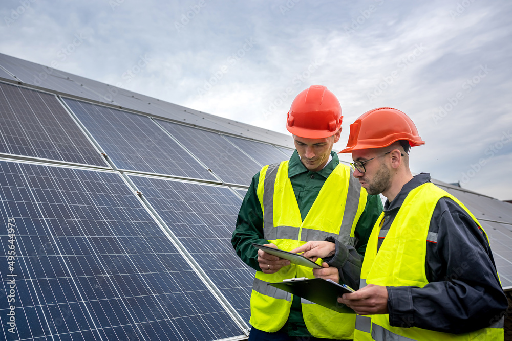 workers dressed in overalls came to inspect the solar panels. workers dressed in overalls came to inspect the solar panels.