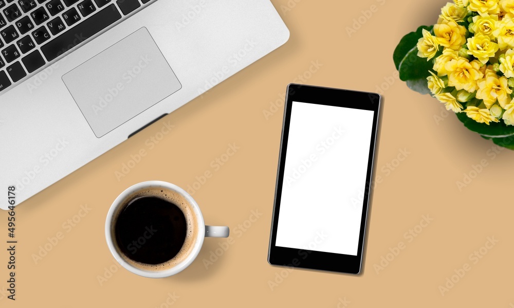 A smartphone with white screen mockup for workplace. Office accessories on table. top view A smartphone with white screen mockup for workplace. Office accessories on table. top view