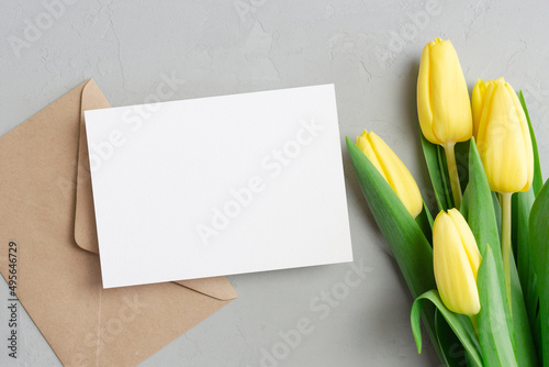 Fototapeta Naklejka Na Ścianę i Meble -  Greeting card mockup with envelope and yellow tulip flowers bouquet