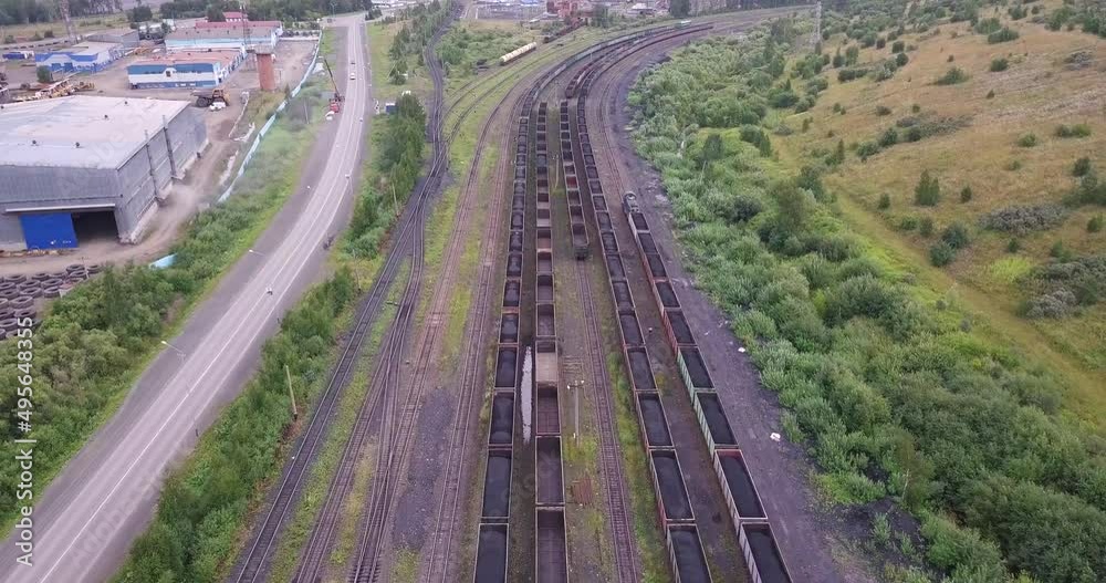 Coal transportation by railroad cars, aerial view. Movement of train cargo cars loaded full with fossil fuel coal, overall plan. Coal transportation by railroad cars, aerial view. Movement of train cargo cars loaded full with fossil fuel coal, overall plan.
