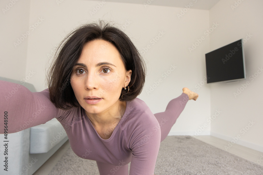 Yoga woman in fitness Wear Doing Exercise at home, standing in pose on carpet, copy space, full length shot. Healthy, sporty lifestyle, yoga practicing at home Yoga woman in fitness Wear Doing Exercise at home, standing in pose on carpet, copy space, full length shot. Healthy, sporty lifestyle, yoga practicing at home