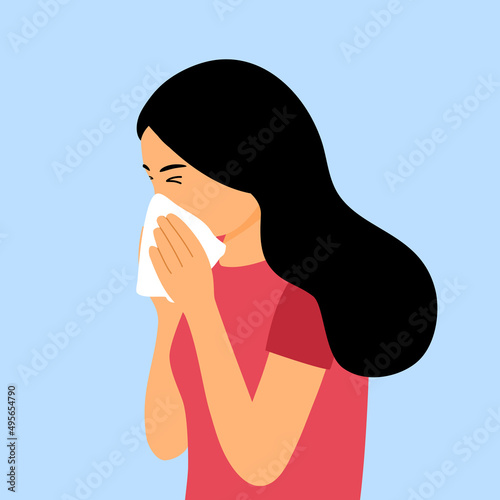 Young woman sneezing in handkerchief. Flu, cold or season allergy.
