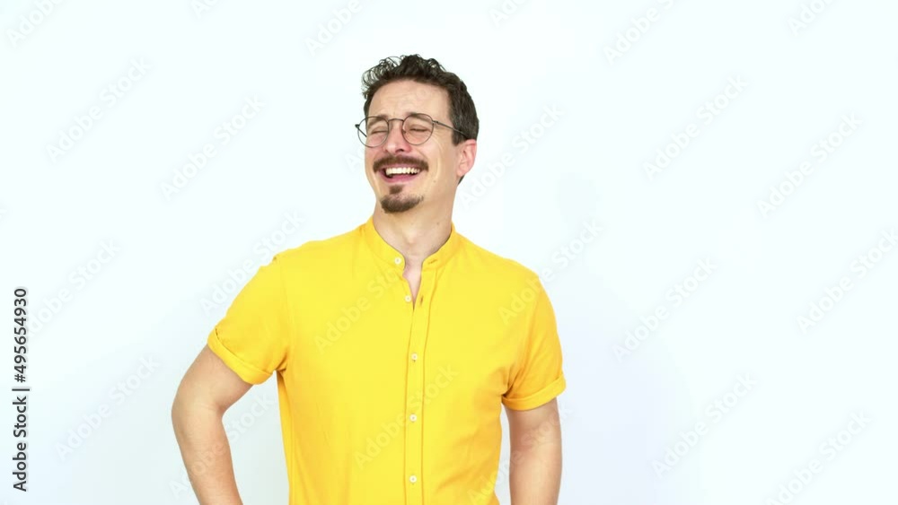 Man posing with arms at hip and laughing over isolated background Man posing with arms at hip and laughing over isolated background