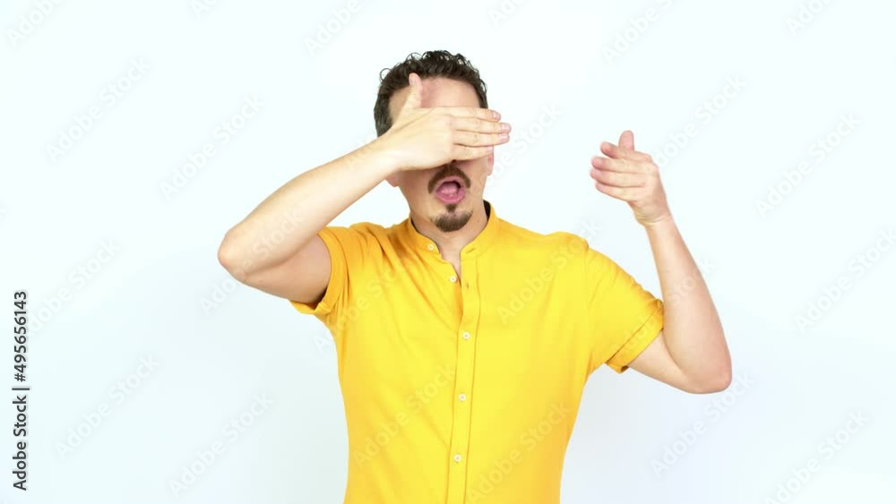 Man covering eyes by hands. Surprised to see what is ahead over isolated background Man covering eyes by hands. Surprised to see what is ahead over isolated background