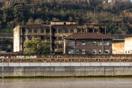 Ruined abandoned industrial building on the Nervion River in Bilbao