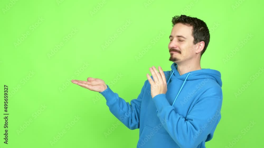 Man presenting something over isolated background. Green screen chroma key Man presenting something over isolated background. Green screen chroma key