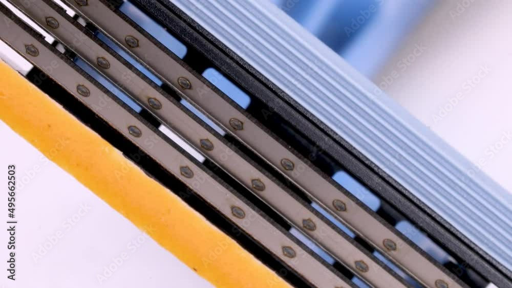 Close up view of a disposable shaver razor blade rotating on white background, macro shot in 4k. Close up view of a disposable shaver razor blade rotating on white background, macro shot in 4k.