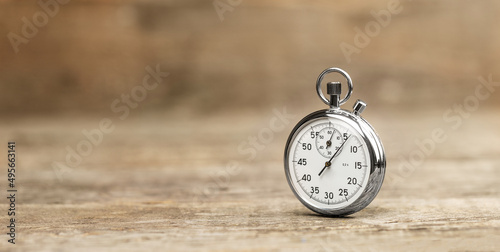 Stopwatch on a wooden background. Copy space for text