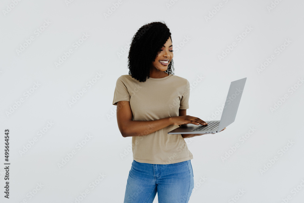 Happy afro woman using laptop isolated over white background Happy afro woman using laptop isolated over white background