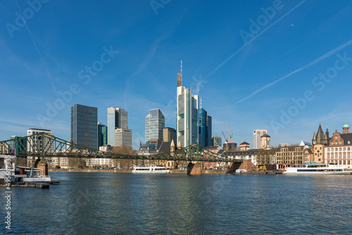 Downtown Frankfurt am Main with Eiserner Steg pedestrian bridge crossing Main river in foreground