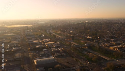 Modesto California Stanislaus County. Drone over city at sunrise with cars driving on interstate freeway 99. photo