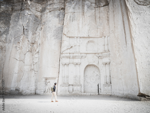 Tableau sur toile Wide angle view of a caucasian man looking at the stone wall sculpture of Petra in Ruta del Sillar, Arequipa, Peru