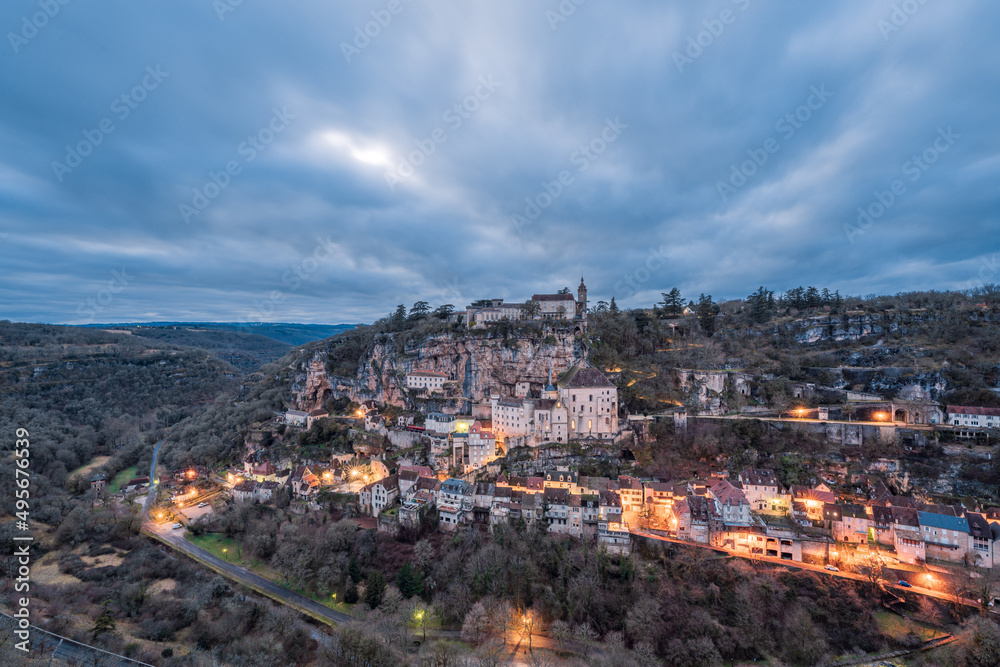 Panoramic view of an ancient french village and castle on cliff, famous Rocamadour at night in France