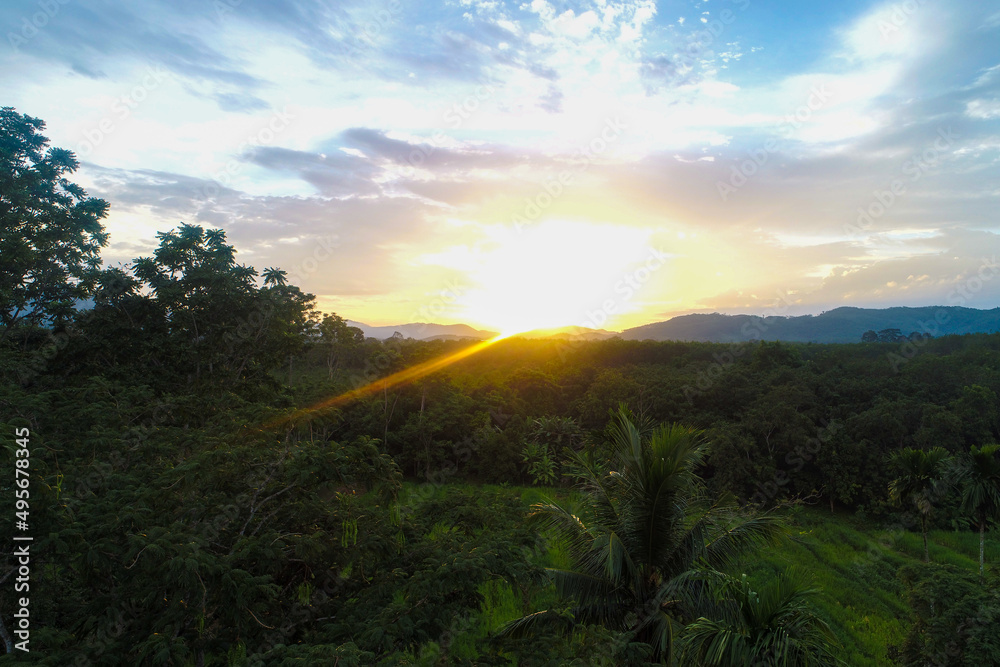 Fototapeta premium Aerial view mountain sunrise in tropical forest with cloud