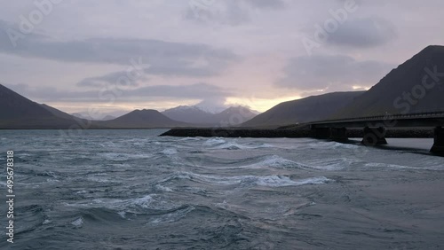 View during auto trip in West Iceland, Kolgrafafjordur fjord bay. Tidal wave in the riverbed. Spectacular Icelandic landscape with  scenic nature: mountains, ocean coast, fjord, clouds, glacier. photo