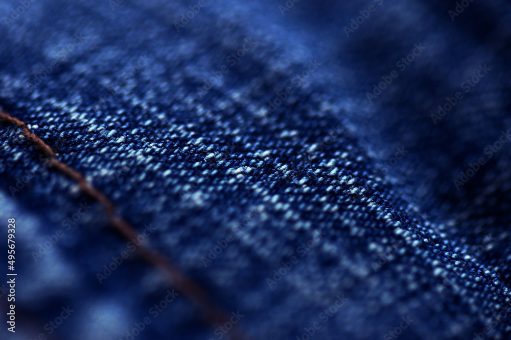 Blue Jeans denim texture close up , focus only one point , soft blured background wallpaper