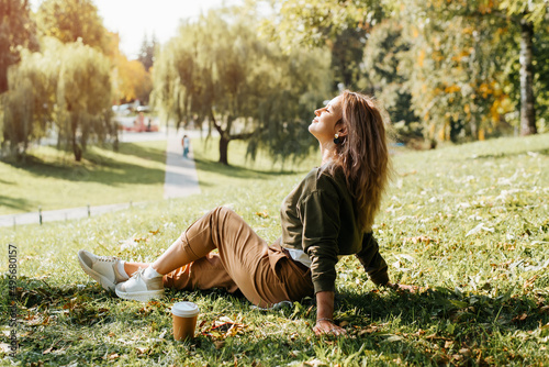 Photography Young caucasian woman resting carefree, relaxing on lawn on sunny day
