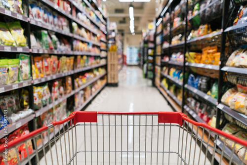 Shopping cart view in supermarket. Supermarket aisle trolley view.
