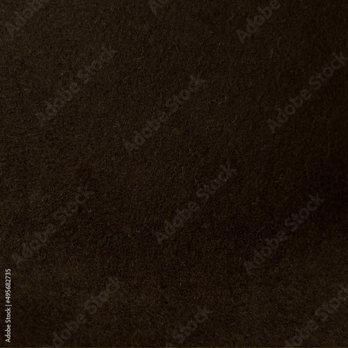 Closeup shot of a fence and dark brown fabric made of synthetic thread photo