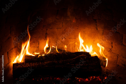 Burning fireplace  wood logs  cozy warm home